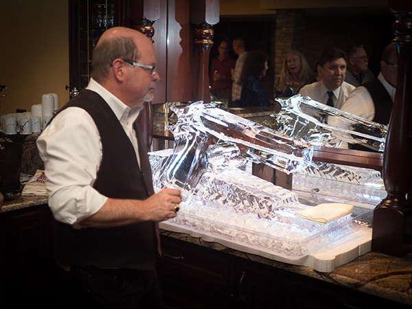 My lovely bride, Joy, surprised me with this massive pistol ice sculpture, which doubled as a liquor flume. Your pour the booze into the hammer, and it comes out cold through the muzzle.