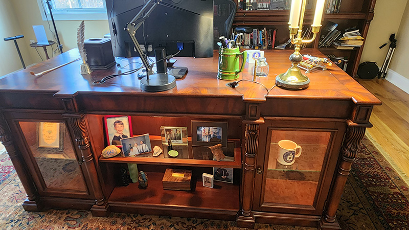 A large desk with photos and trinkets